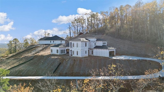 rear view of property with a garage