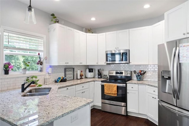 1016 Buckeye Ln, Villa Rica, GA 30180 - kitchen featuring stainless steel appliances, a sink, a peninsula, white cabinets, and recessed lighting