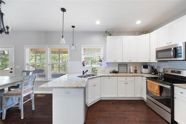 1016 Buckeye Ln, Villa Rica, GA 30180 - kitchen featuring stainless steel appliances, a peninsula, a sink, healthy amount of natural light, and recessed lighting