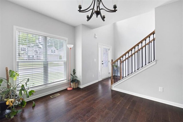 1016 Buckeye Ln, Villa Rica, GA 30180 - entryway with a chandelier, baseboards, stairway, and wood finished floors