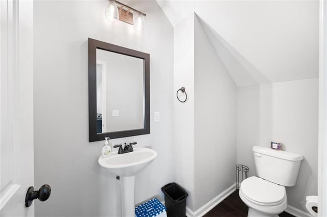 1016 Buckeye Ln, Villa Rica, GA 30180 - bathroom with toilet, vaulted ceiling, baseboards, and wood finished floors