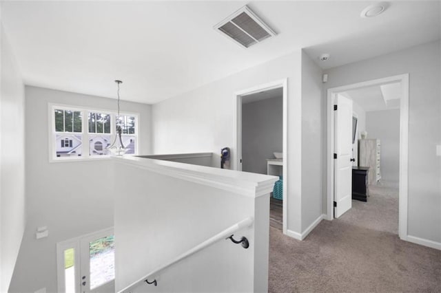 1016 Buckeye Ln, Villa Rica, GA 30180 - corridor with an upstairs landing, a chandelier, carpet flooring, and baseboards