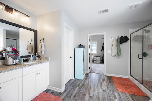 1016 Buckeye Ln, Villa Rica, GA 30180 - bathroom with wood finished floors, vanity, a shower stall, and baseboards