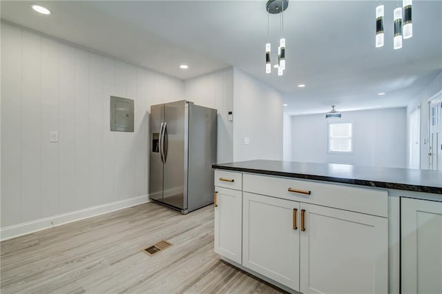 kitchen featuring pendant lighting, stainless steel fridge with ice dispenser, electric panel, and white cabinets