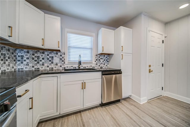 kitchen featuring sink, dishwasher, white cabinets, light hardwood / wood-style floors, and backsplash