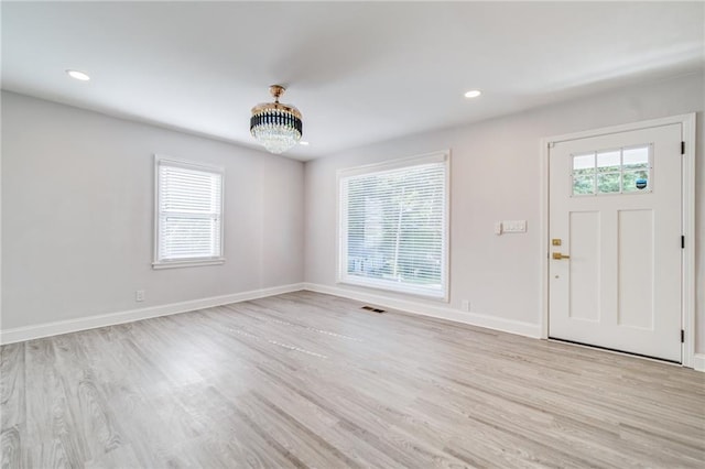 entryway with a chandelier and light hardwood / wood-style flooring