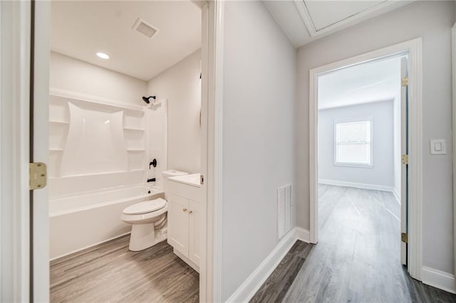 full bathroom with vanity, hardwood / wood-style floors, bathtub / shower combination, and toilet