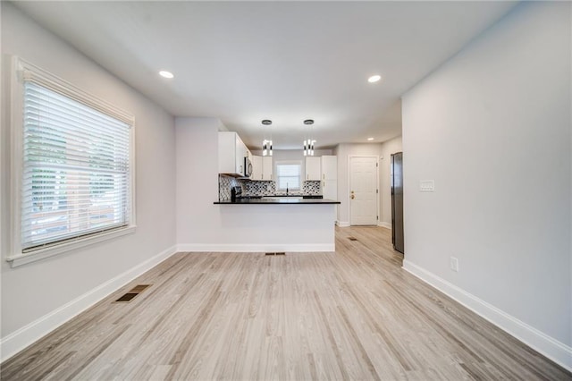 unfurnished living room with light hardwood / wood-style floors