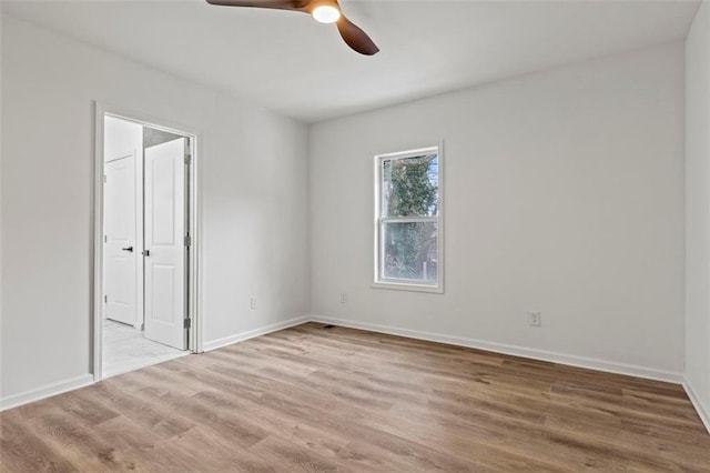 spare room featuring ceiling fan and light hardwood / wood-style floors