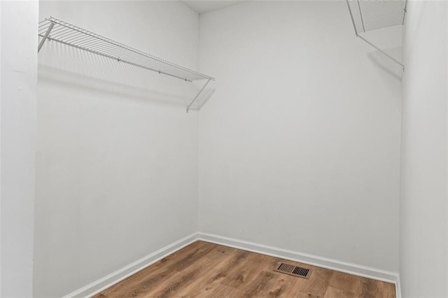 spacious closet featuring hardwood / wood-style floors