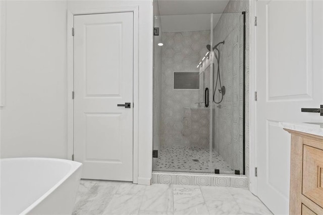 bathroom with vanity and separate shower and tub