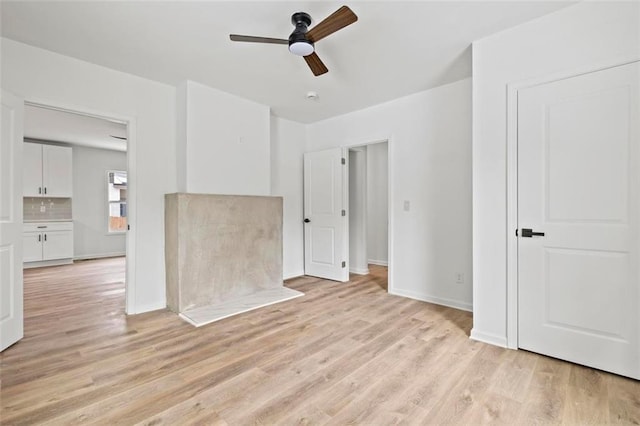 spare room featuring light hardwood / wood-style flooring and ceiling fan