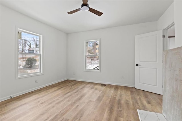 unfurnished room with ceiling fan and light wood-type flooring