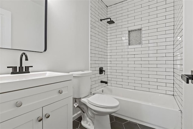 full bathroom with tile patterned flooring, tiled shower / bath, vanity, and toilet