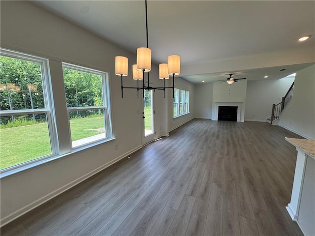23 Gresham Ct, Dawsonville, GA 30534 - unfurnished living room with wood finished floors, a fireplace, stairway, a chandelier, and ceiling fan