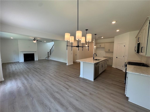 23 Gresham Ct, Dawsonville, GA 30534 - kitchen featuring stainless steel appliances, a chandelier, wood finished floors, a center island with sink, and recessed lighting
