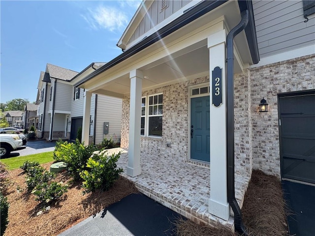 23 Gresham Ct, Dawsonville, GA 30534 - doorway to property with covered porch, board and batten siding, and stone siding