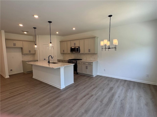 23 Gresham Ct, Dawsonville, GA 30534 - kitchen featuring appliances with stainless steel finishes, a chandelier, dark wood finished floors, an island with sink, and recessed lighting