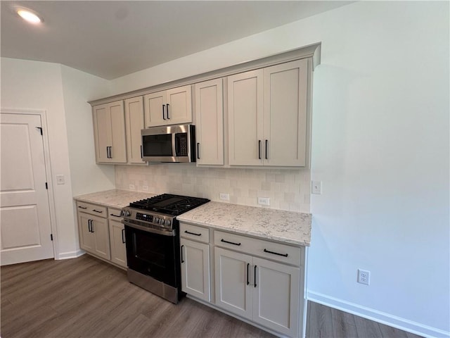 23 Gresham Ct, Dawsonville, GA 30534 - kitchen with appliances with stainless steel finishes, dark wood-type flooring, decorative backsplash, and light stone counters