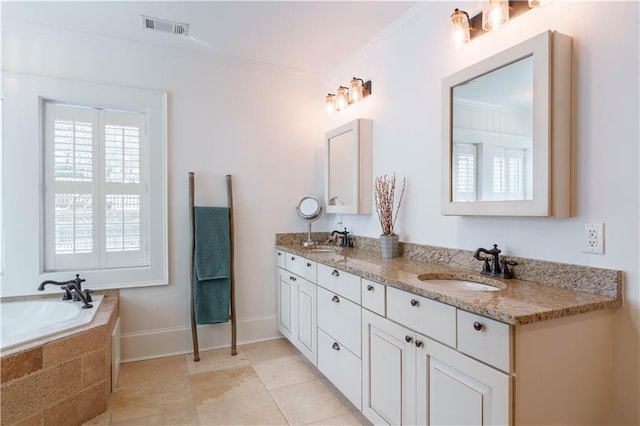 bathroom with visible vents, a sink, a garden tub, and double vanity