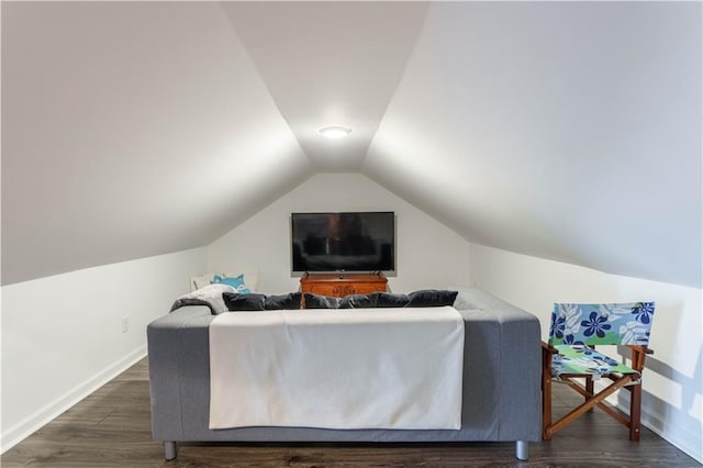 living room featuring lofted ceiling, baseboards, and wood finished floors