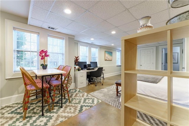 dining area with recessed lighting, visible vents, concrete flooring, a drop ceiling, and baseboards