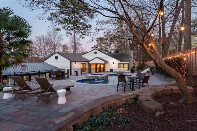 view of pool featuring a patio area and a pool with connected hot tub