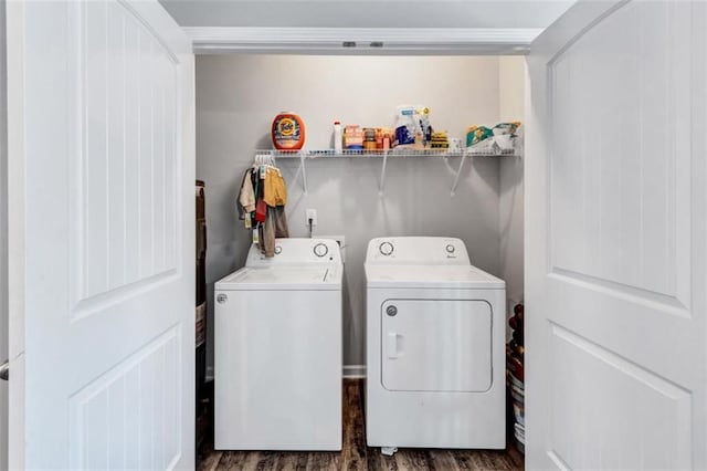 laundry area featuring washing machine and dryer, wood finished floors, and laundry area