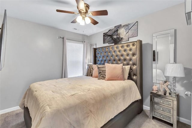 carpeted bedroom with baseboards, visible vents, and a ceiling fan