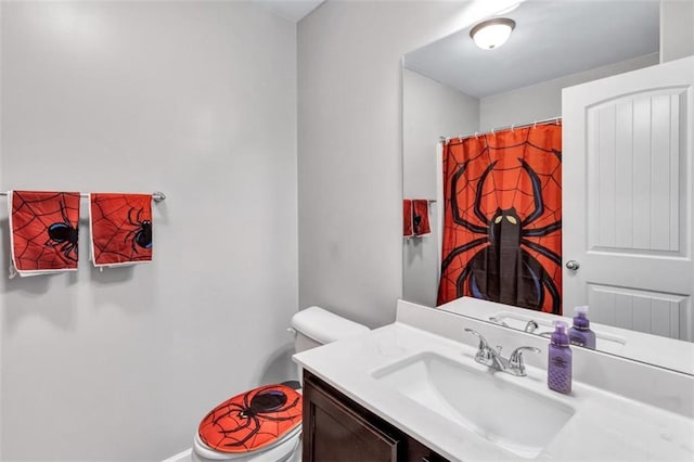 bathroom with toilet, vanity, and a shower with curtain