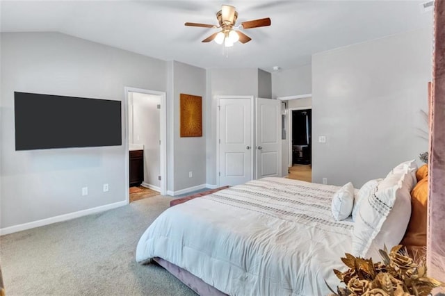 carpeted bedroom with visible vents, baseboards, connected bathroom, ceiling fan, and lofted ceiling