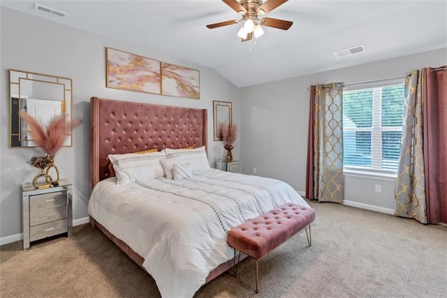 bedroom with visible vents, carpet, and vaulted ceiling