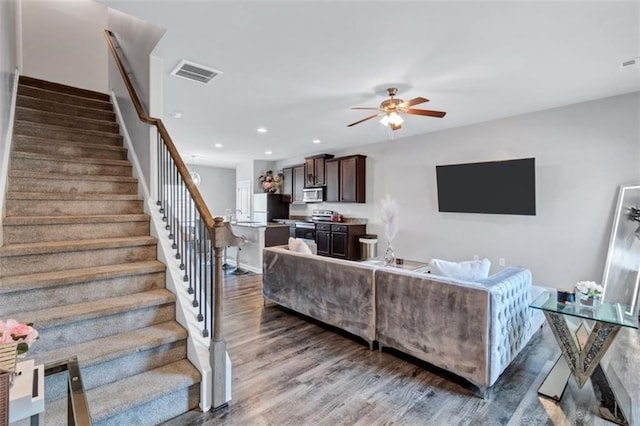 living area with stairway, recessed lighting, visible vents, a ceiling fan, and wood finished floors