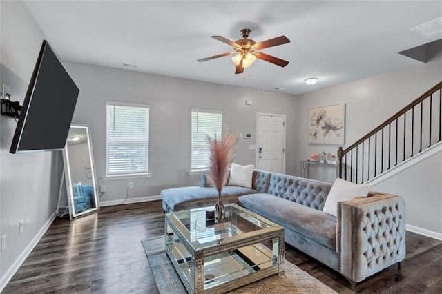 living area with dark wood-style floors, ceiling fan, and baseboards
