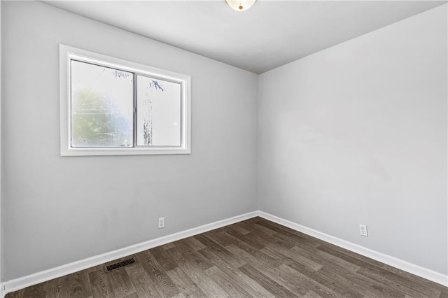 unfurnished room featuring dark hardwood / wood-style floors