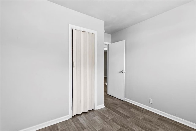 unfurnished bedroom featuring dark hardwood / wood-style floors