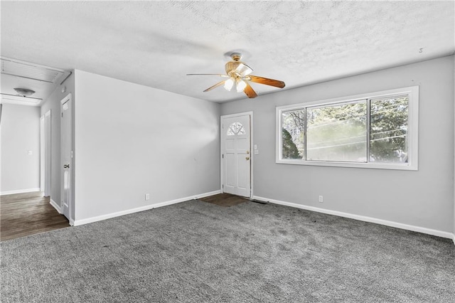 carpeted empty room with a textured ceiling and ceiling fan