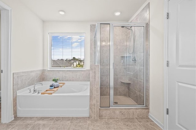 bathroom featuring tile patterned floors and separate shower and tub