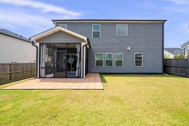 back of house with a yard and a patio