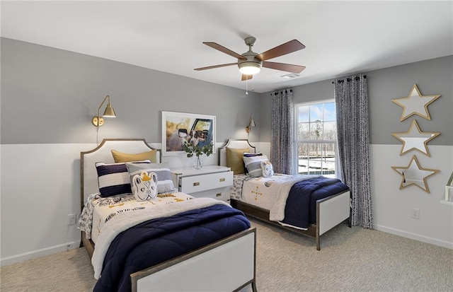 carpeted bedroom with baseboards, visible vents, and a ceiling fan