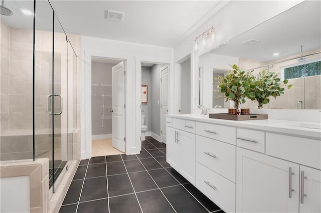 full bathroom with toilet, visible vents, a shower stall, and a sink