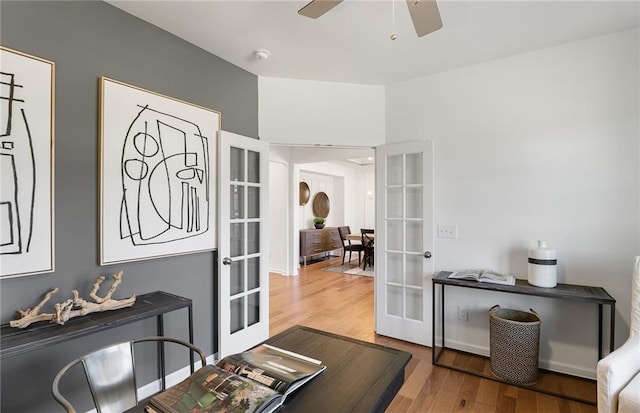 entryway featuring wood finished floors, a ceiling fan, and french doors