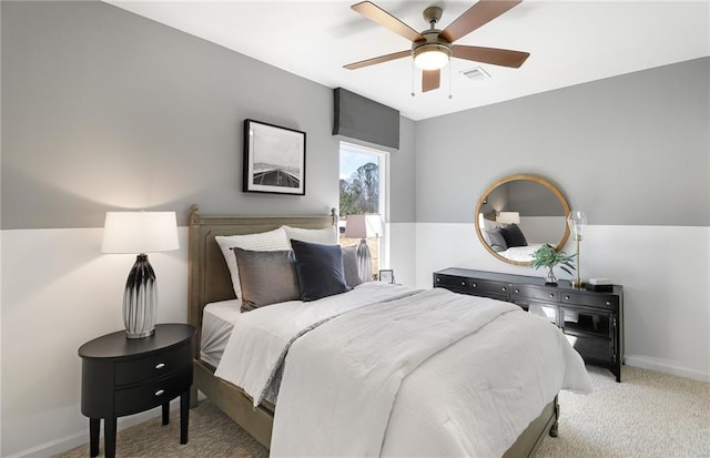 bedroom featuring visible vents, ceiling fan, baseboards, and light carpet