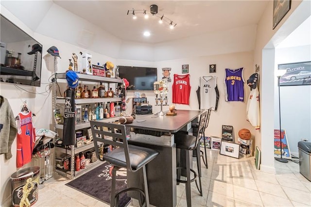 kitchen featuring light tile patterned flooring and a kitchen bar