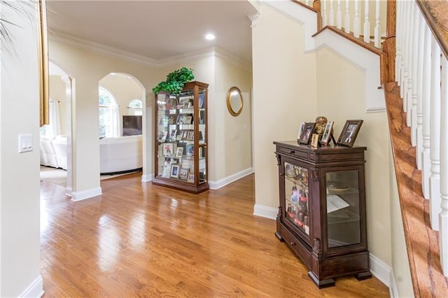 interior space featuring light hardwood / wood-style floors and crown molding