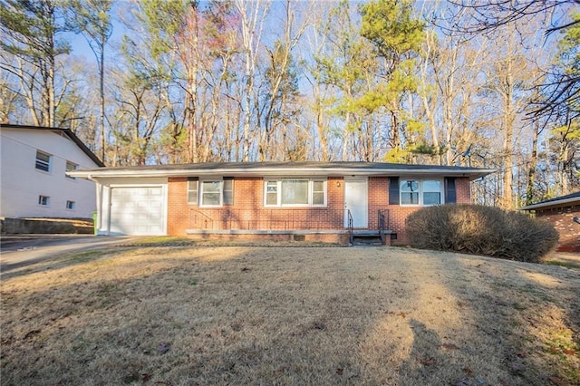 ranch-style house featuring an attached garage, driveway, a front yard, and brick siding