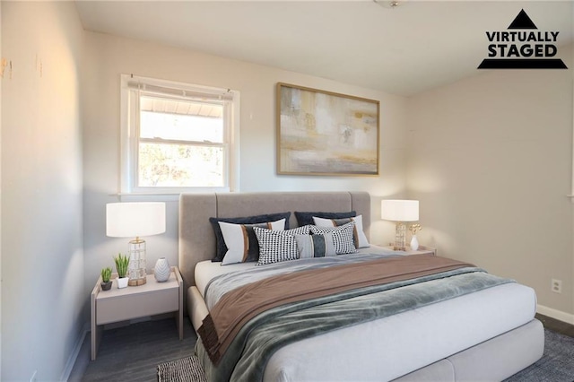 bedroom with wood finished floors and baseboards