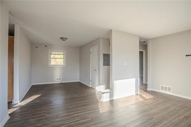 empty room with visible vents, baseboards, and wood finished floors