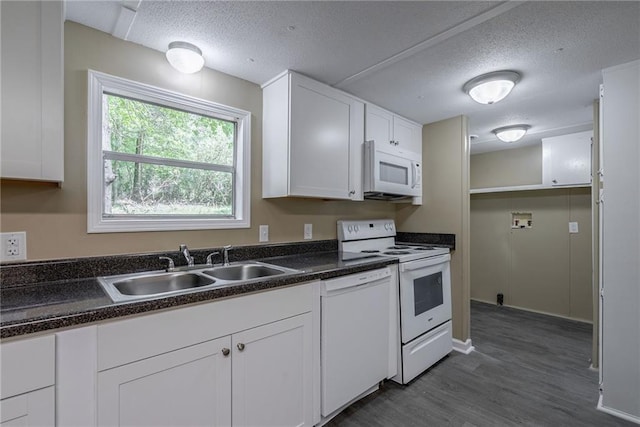 kitchen with sink, dark hardwood / wood-style floors, a textured ceiling, white appliances, and white cabinets