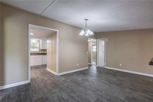 unfurnished dining area with ornamental molding, dark hardwood / wood-style floors, and a notable chandelier